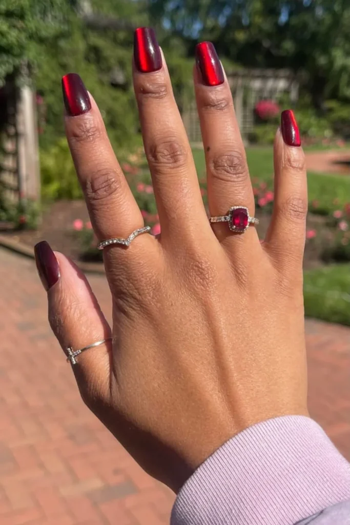 Deep burgundy cat-eye velvet manicure perfect for transitional end of summer nails into fall