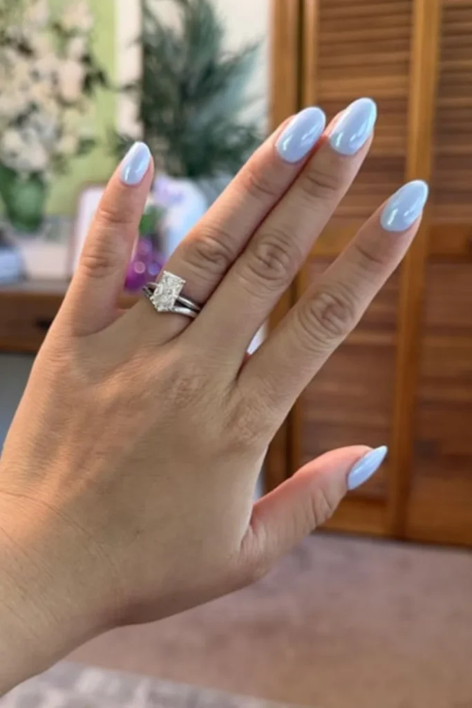 Light baby blue chrome glazed donut nails showcased on almond-shaped end of summer nails
