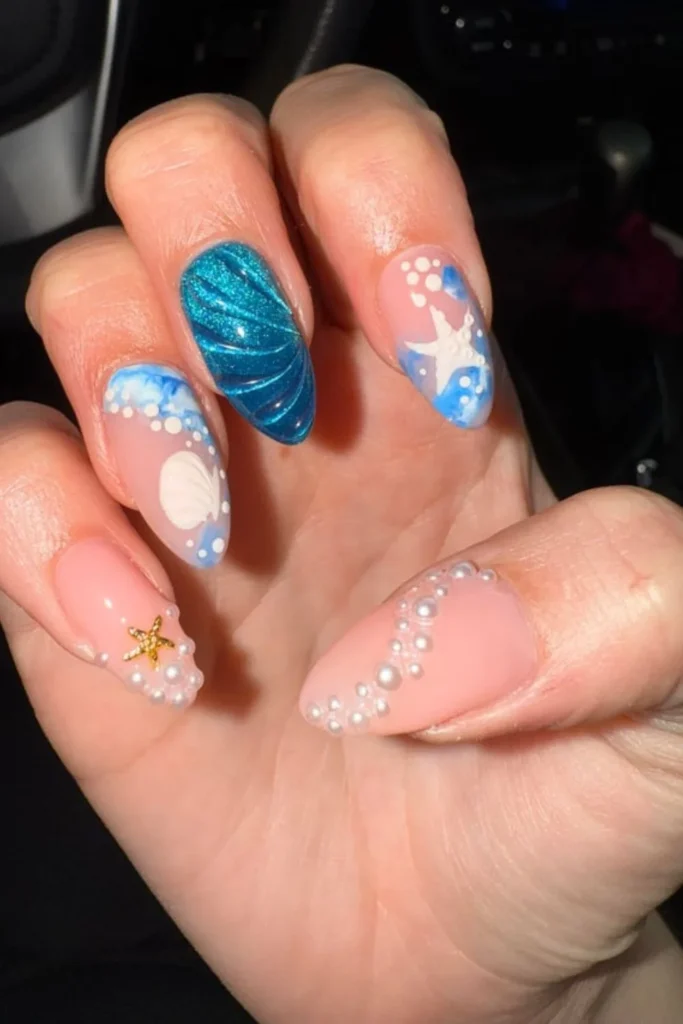 Ocean beach theme nails with 3D seashells, pearls, and starfish details for end of summer nails