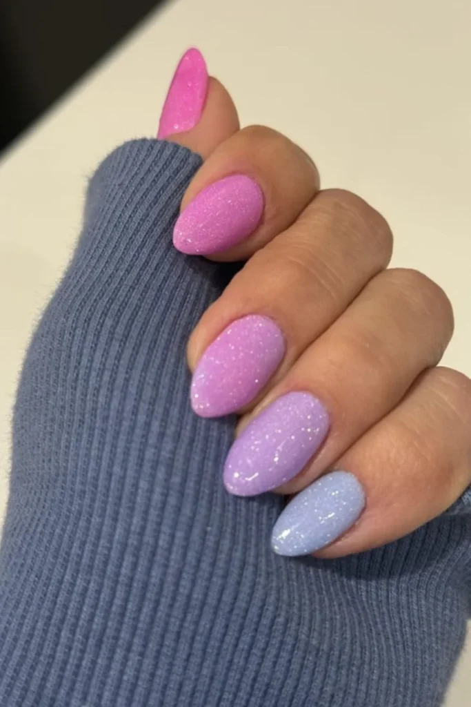 Pastel pink-to-blue glitter gradient ombre manicure for soft end of summer nails