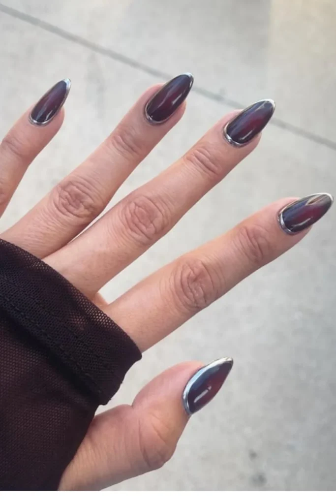 Futuristic gothic September nails ideas featuring long almond-shaped deep burgundy jelly nails framed with 3D silver metallic chrome borders