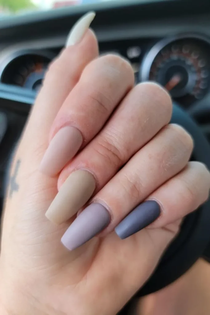 Muted autumn September nails ideas featuring long coffin nails styled in a matte gradient transition from cream and beige to dusty mauve and dark slate blue