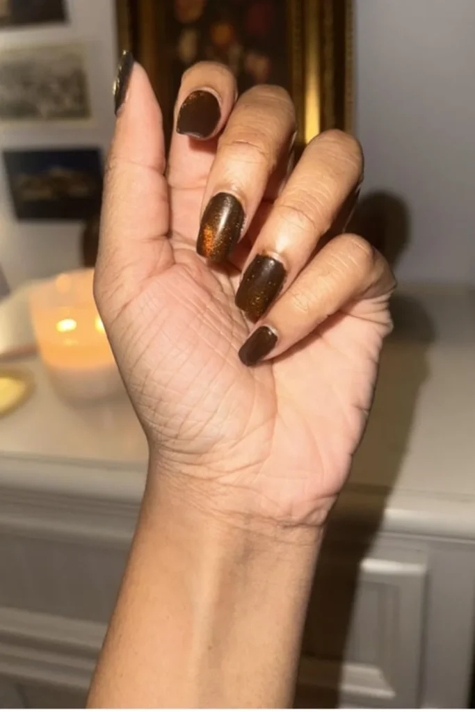 Warm autumn September nails ideas featuring square-shaped nails styled in a deep chocolate brown magnetic cat-eye shimmer